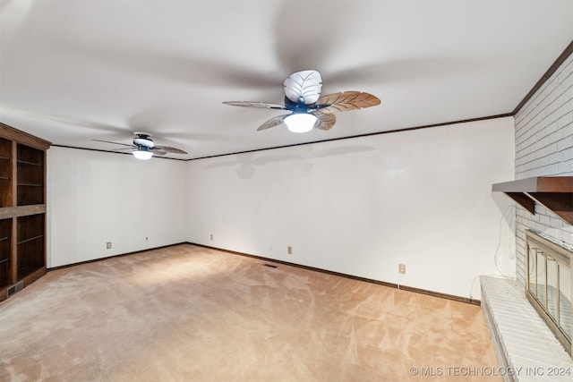 interior space with light carpet, crown molding, a fireplace, and ceiling fan