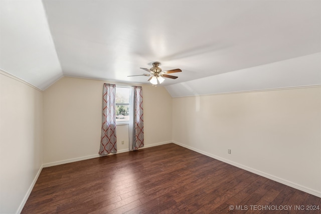 additional living space with lofted ceiling, dark hardwood / wood-style floors, and ceiling fan