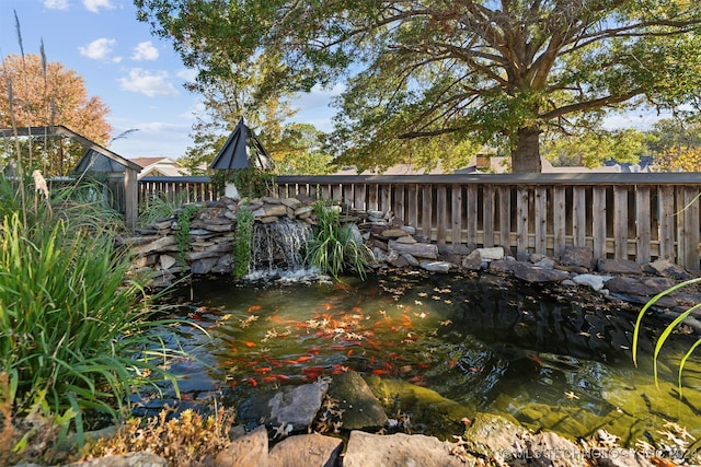 wooden terrace featuring a garden pond