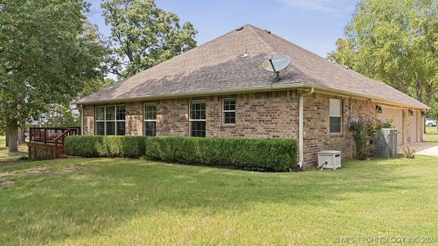 view of side of property featuring a yard and a deck