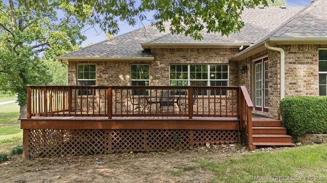 back of property with a wooden deck