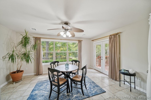 tiled dining space featuring french doors and ceiling fan