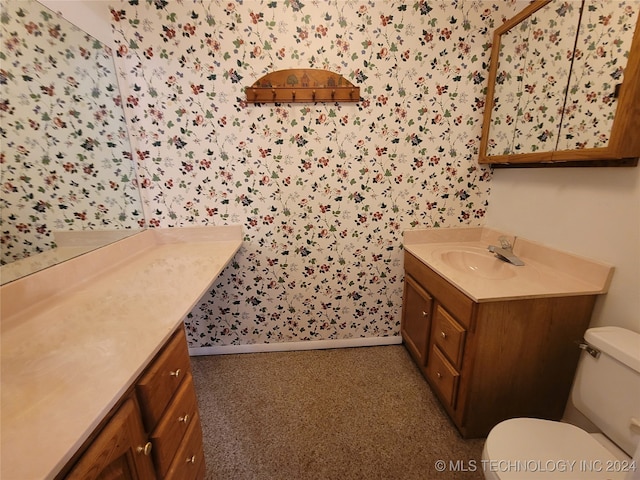 bathroom featuring vanity and toilet