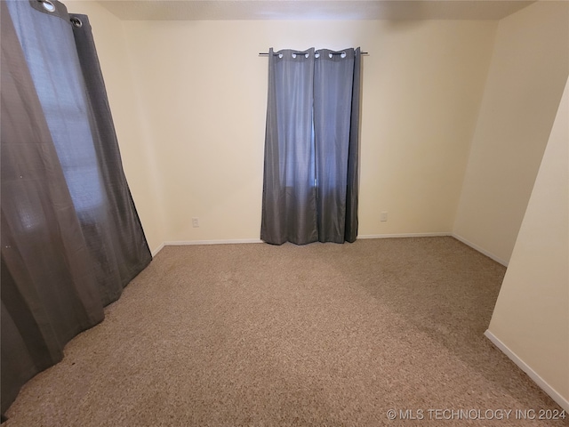 spare room featuring carpet