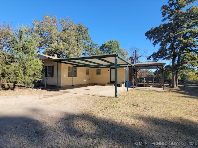 rear view of house with a patio area and a carport