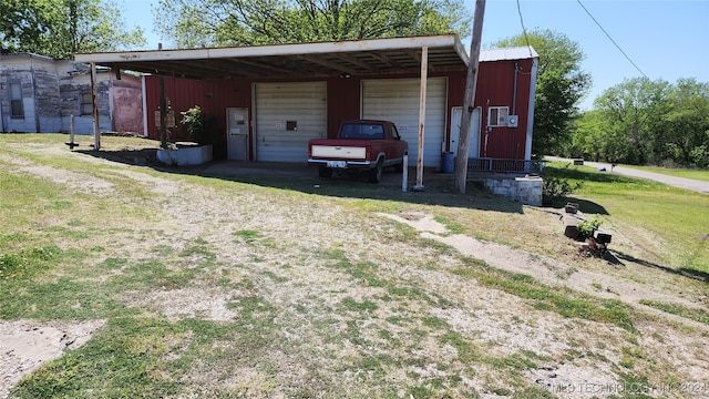 view of outdoor structure with a yard and a carport