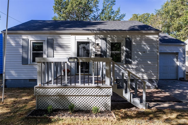 view of front of property with a wooden deck and a garage