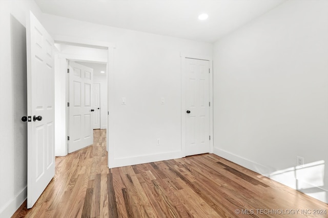 spare room with light hardwood / wood-style flooring