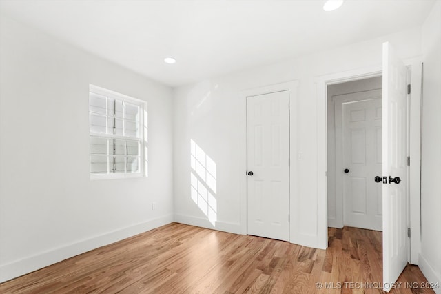 spare room with light hardwood / wood-style flooring