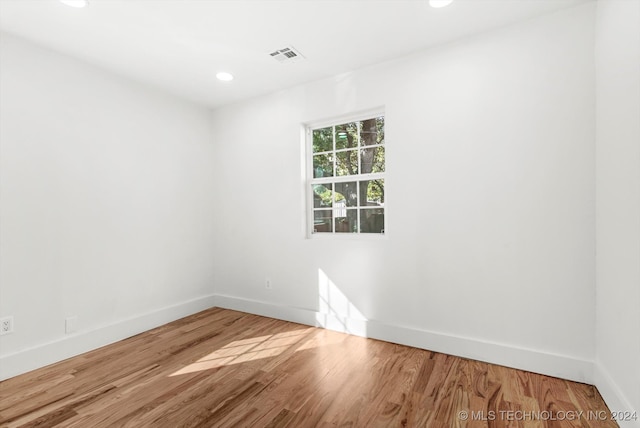 unfurnished room featuring hardwood / wood-style floors