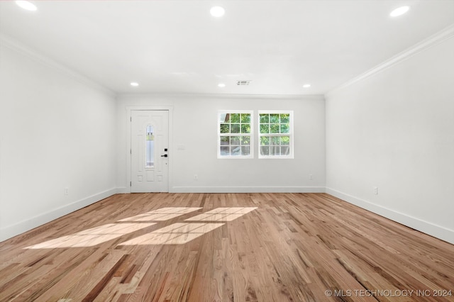 entrance foyer with crown molding and light hardwood / wood-style flooring