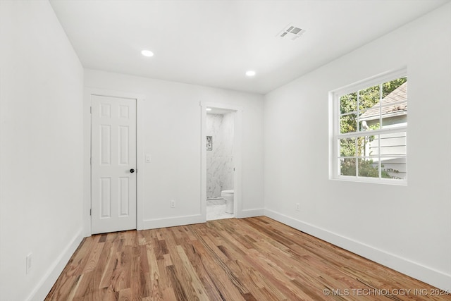 empty room with light hardwood / wood-style flooring