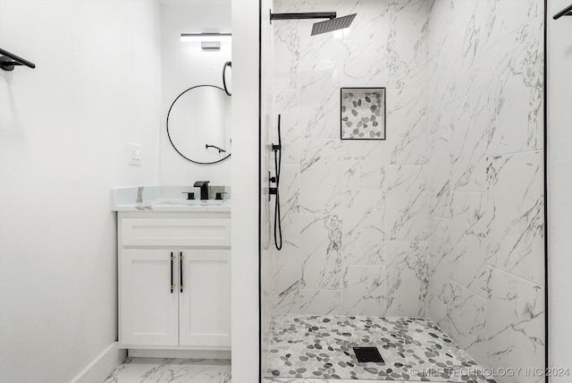 bathroom with vanity and tiled shower