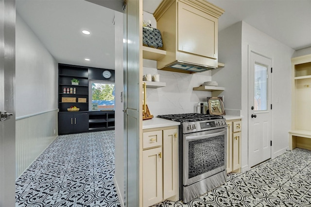 kitchen featuring built in features, stainless steel gas range, and decorative backsplash