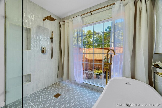 bathroom featuring shower with separate bathtub