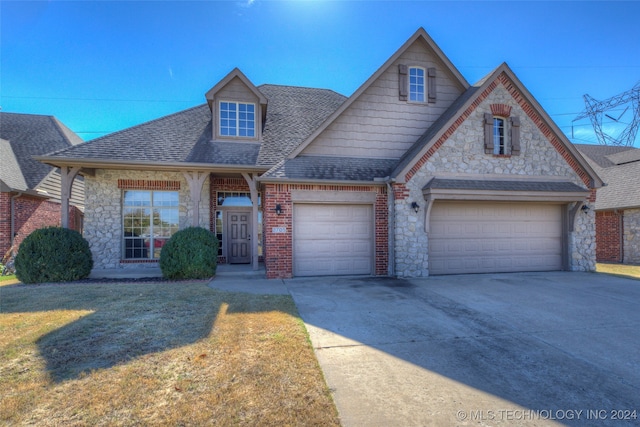 view of front of property featuring a garage and a front lawn