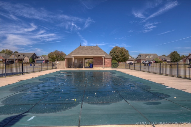 view of pool with an outbuilding