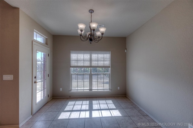 interior space with light tile patterned floors and a chandelier