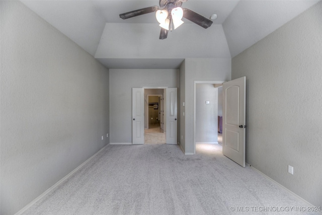 unfurnished bedroom featuring lofted ceiling, light colored carpet, and ceiling fan