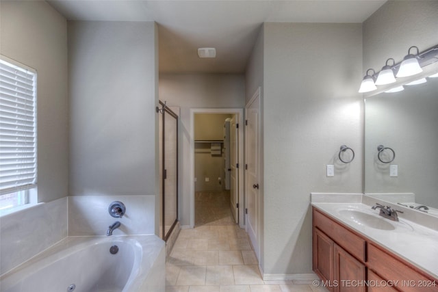 bathroom featuring vanity, shower with separate bathtub, and tile patterned floors