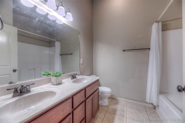 full bathroom featuring tile patterned flooring, vanity, toilet, and shower / bath combo with shower curtain