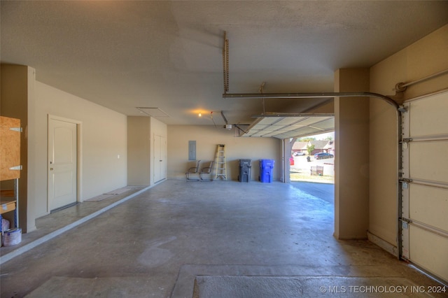 garage featuring a garage door opener and electric panel