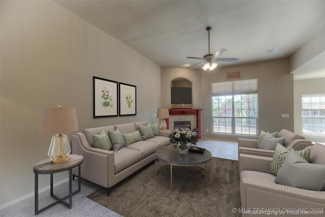 living room featuring carpet flooring, a wealth of natural light, and ceiling fan