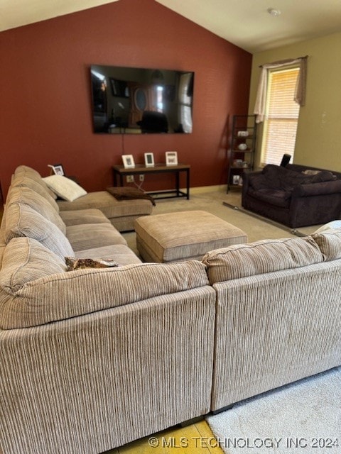 living room featuring carpet flooring and lofted ceiling