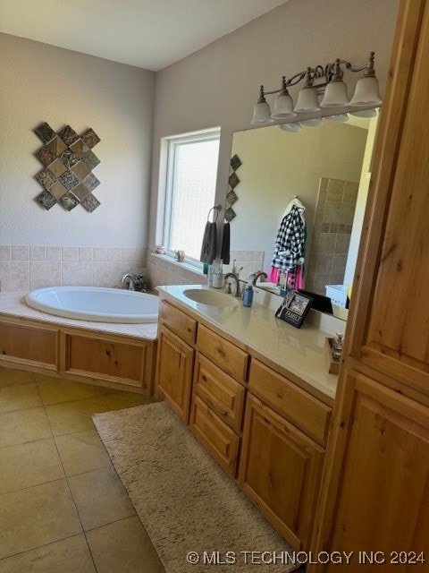 bathroom featuring vanity, a washtub, and tile patterned flooring