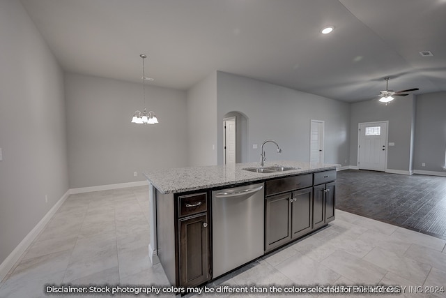 kitchen featuring sink, dishwasher, light wood-type flooring, hanging light fixtures, and a center island with sink