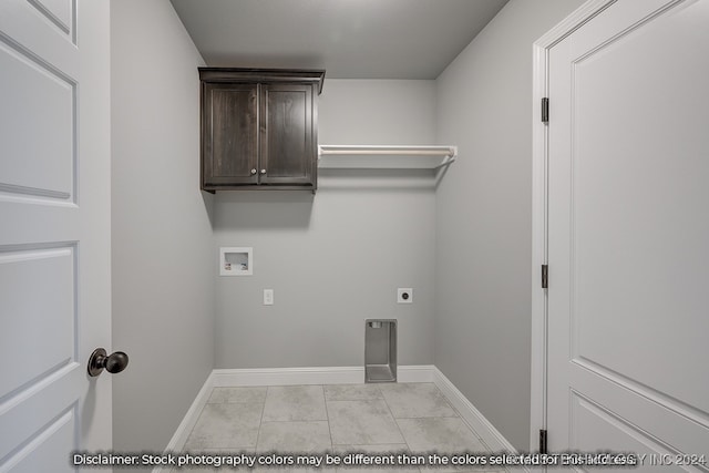 clothes washing area with hookup for a washing machine, electric dryer hookup, and light tile patterned floors