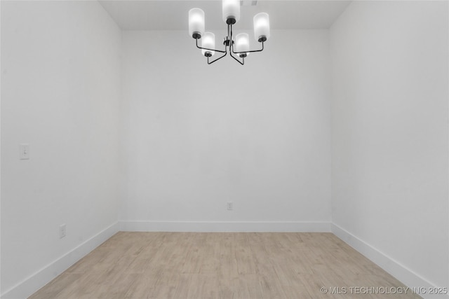 10804 S 274th Ave E, Coweta, OK 74429 - unfurnished dining area with a chandelier, light wood-style flooring, and baseboards