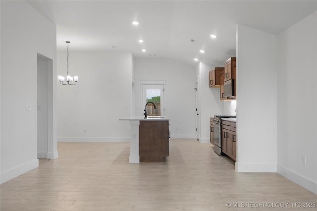 10804 S 274th Ave E, Coweta, OK 74429 - kitchen featuring stainless steel appliances, a chandelier, light wood-style flooring, lofted ceiling, and a sink