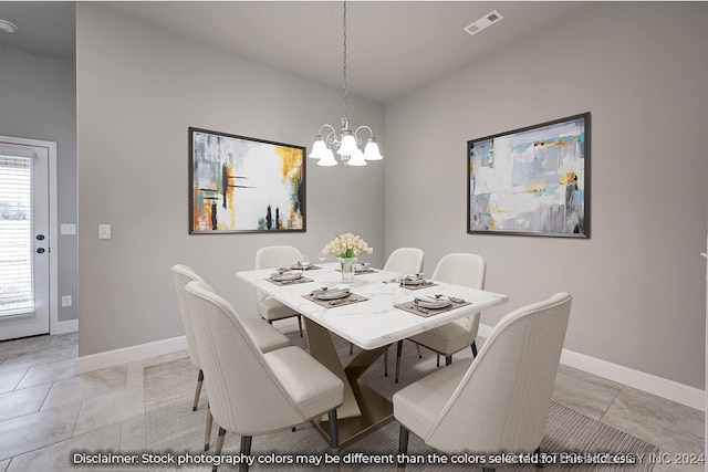 tiled dining room with an inviting chandelier