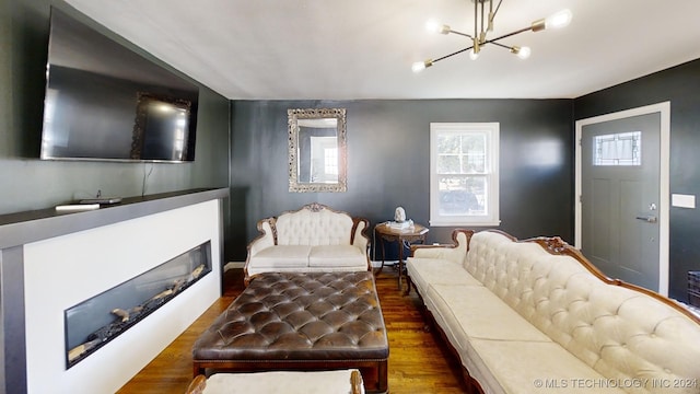 living room featuring a chandelier and dark hardwood / wood-style flooring