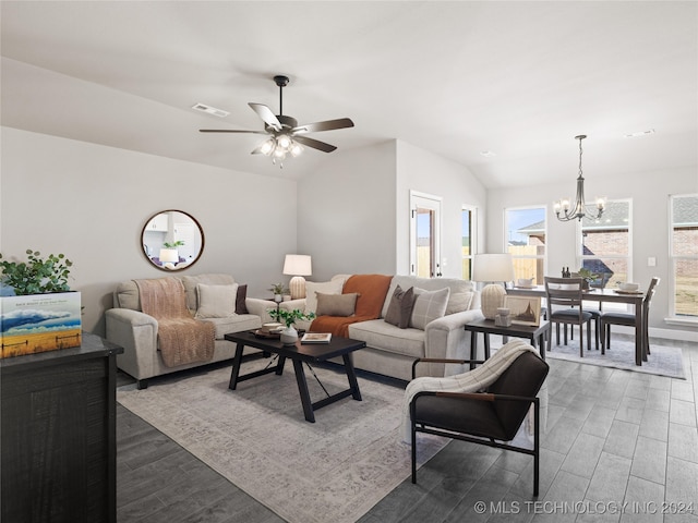 living room with vaulted ceiling, dark hardwood / wood-style flooring, and ceiling fan with notable chandelier