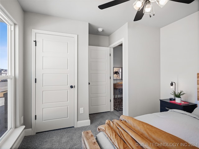 bedroom with dark colored carpet and ceiling fan