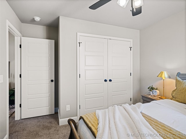 bedroom with dark colored carpet, a closet, and ceiling fan