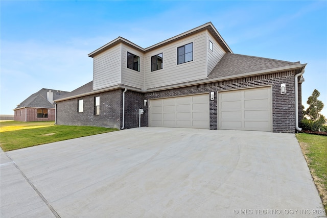 view of property with a front lawn and a garage