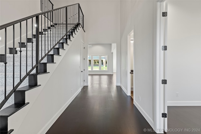 interior space with a high ceiling and hardwood / wood-style flooring