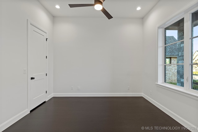 unfurnished room featuring ceiling fan and dark wood-type flooring