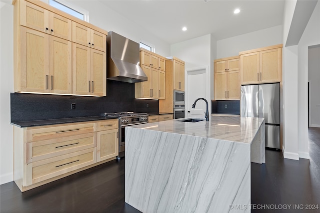 kitchen with light stone countertops, light brown cabinetry, wall chimney exhaust hood, and appliances with stainless steel finishes