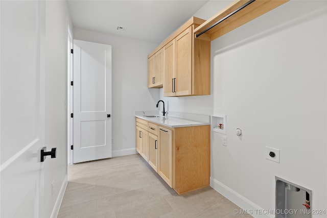 washroom with cabinets, washer hookup, electric dryer hookup, sink, and hookup for a gas dryer