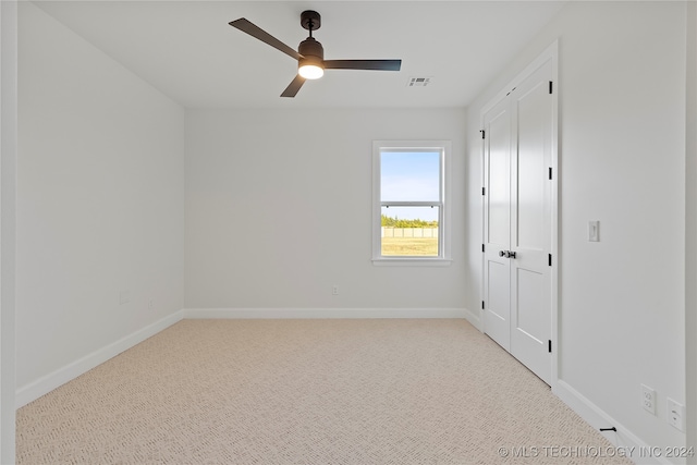 carpeted empty room with ceiling fan