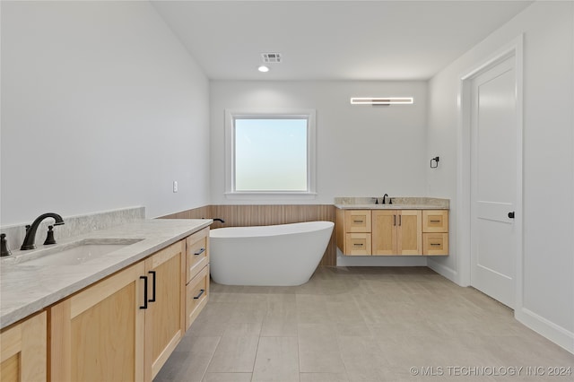 bathroom with vanity and a bathtub