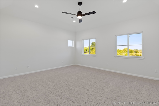 carpeted spare room featuring ceiling fan