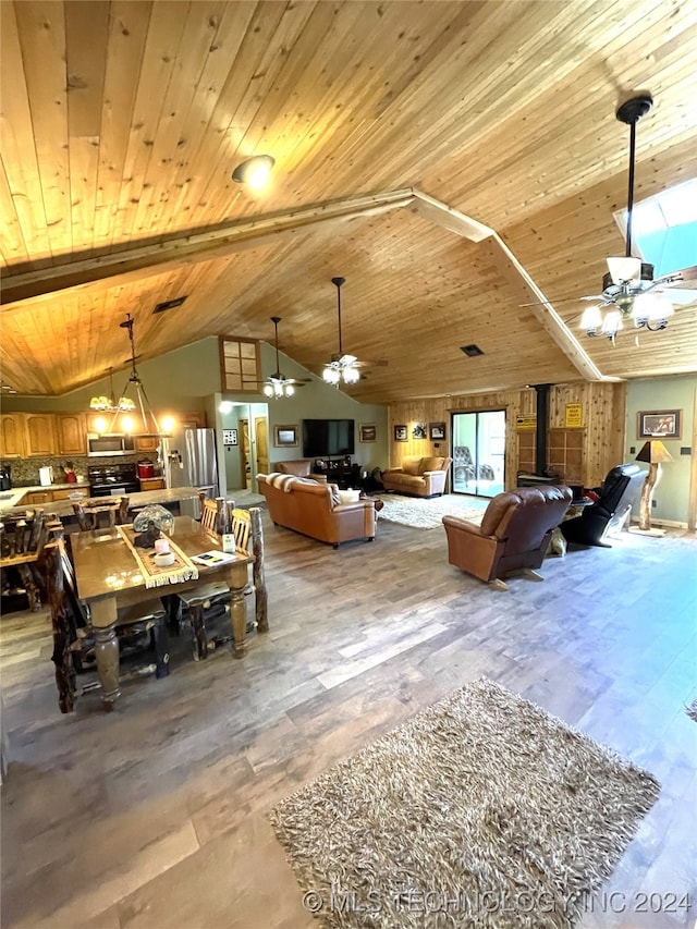 dining room with vaulted ceiling with beams, wood ceiling, and ceiling fan