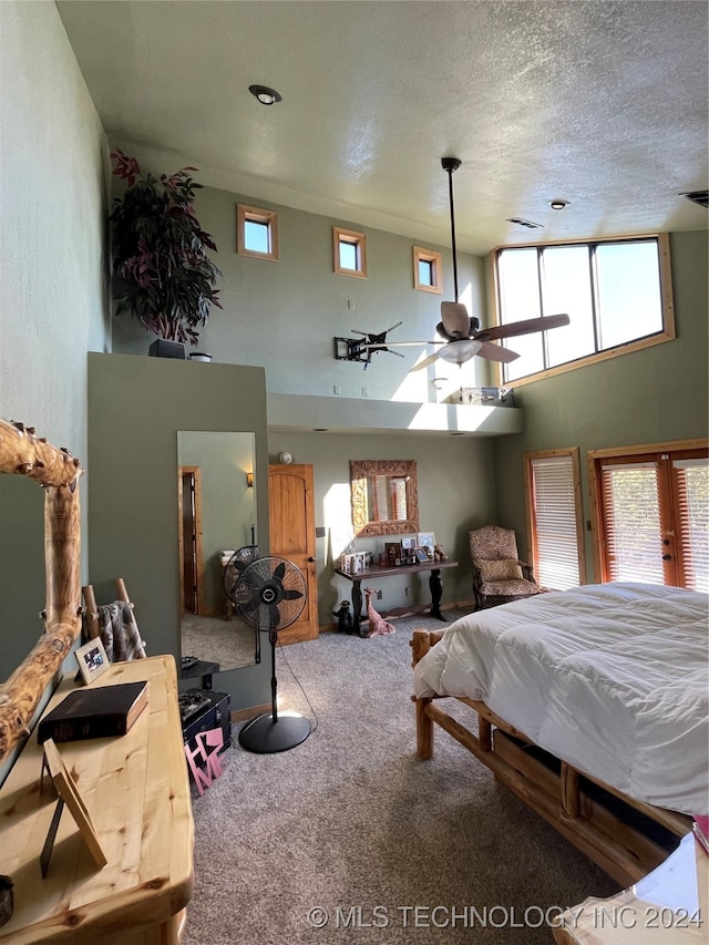 bedroom with carpet and a textured ceiling