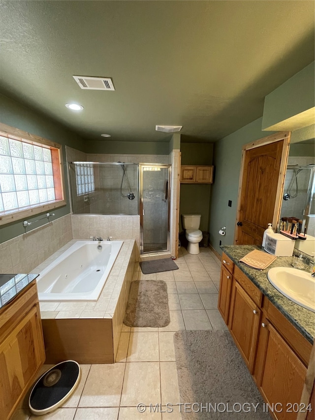 full bathroom with vanity, independent shower and bath, toilet, and tile patterned floors