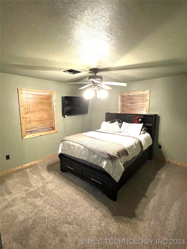 bedroom featuring a textured ceiling, carpet flooring, and ceiling fan